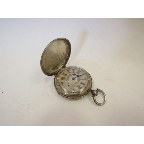 1324 - A white metal hunter pocket watch with ornate floral engraved case stamped Double D'or K18, with sil... 