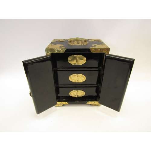 1335 - A miniature Oriental lacquered cabinet with three drawers to interior