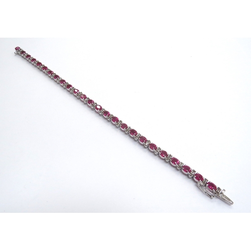 9203 - A ruby and old cut diamond bracelet, unmarked metal, 18cm long