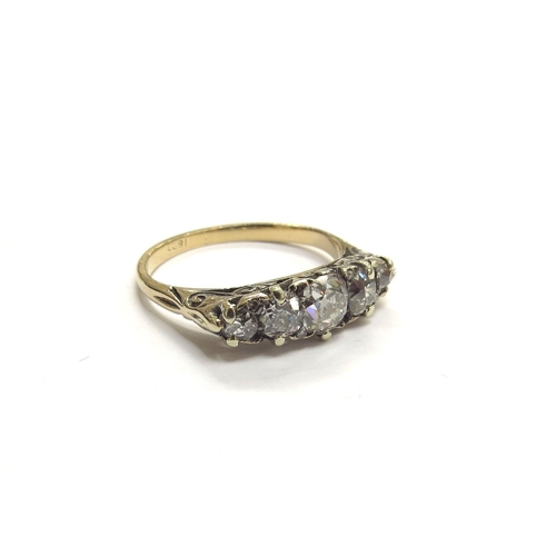 9151 - A five stone diamond ring, the five graduated old cut diamonds spaced by small old cut diamonds (3 m... 