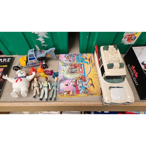 7027 - A group of vintage playworn The Real Ghostbusters toys including jigsaw puzzle, Ecto-1 and Ecto-2 ve... 