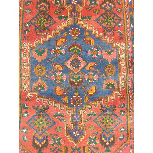 2325 - A handwoven Persian pink red and blue carpet. 133cmx 247cm   (R) £200