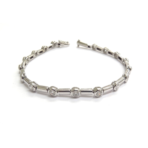 9009 - An 18ct white gold bracelet set with seventeen diamonds in rubover settings, 19cm long, 13.3g