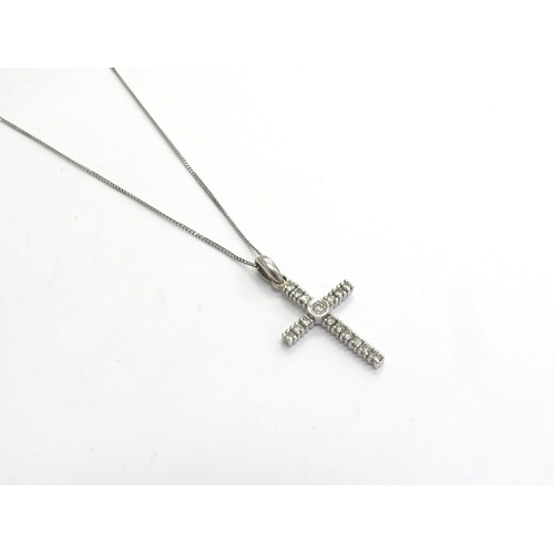 9046 - A 9ct white gold diamond set cross pendant hung on a white gold chain, 375, 50cm long, 1.9g