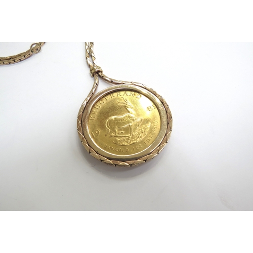 9068 - A 1981 1oz gold Kruggerand in loose 9ct gold pendant mount hung on 9ct gold chain, 54.5g total