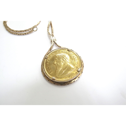 9068 - A 1981 1oz gold Kruggerand in loose 9ct gold pendant mount hung on 9ct gold chain, 54.5g total