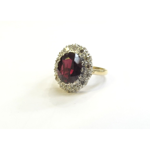 9149 - An 18ct gold garnet and diamond cluster ring, 16mm x 12mm. Size K, 4.7g   (R) £250