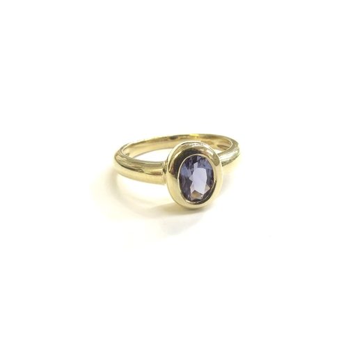 9214 - A 9ct gold collet set oval tanzanite ring. Size L, 2.7g