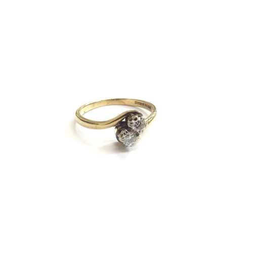 9163 - A 9ct gold diamond crossover ring. Size P, 2.1g