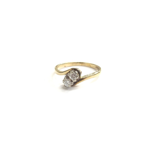 9163 - A 9ct gold diamond crossover ring. Size P, 2.1g