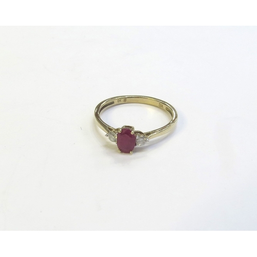 9161 - A ruby and diamond ring, the central oval ruby flanked by round cut diamonds, stamped 9k. Size O, 1.... 