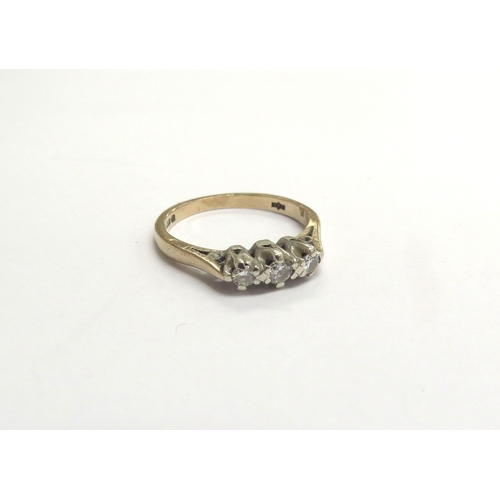 9395 - A 9ct gold three stone diamond ring. Size K, 2g      (C)