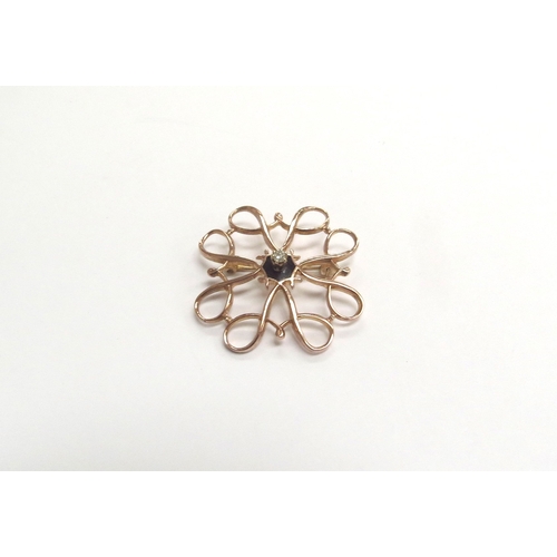 9228 - A 9ct rose gold scroll brooch centrally set with a single diamond on a black enamel base, 2.5g   (C)