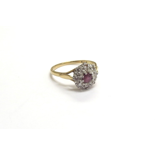 9335 - An 18ct gold ruby and diamond cluster ring. Size U, 4.3g        (C)