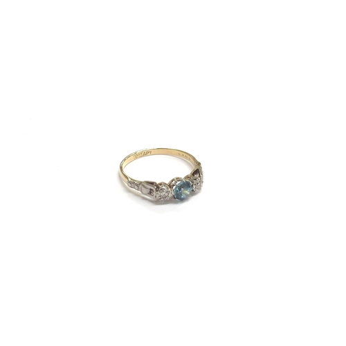 9212 - An 18ct gold platinum set ring centrally set with a blue zircon flanked by small diamonds. Size Q, 2... 