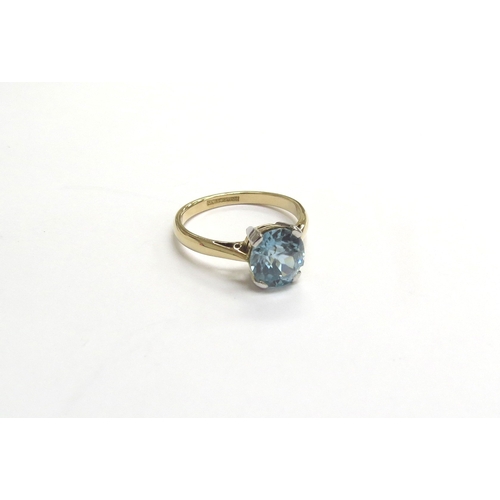 9207 - An 18ct gold platinum set blue zircon solitaire ring. Size M, 3.1g   (C)