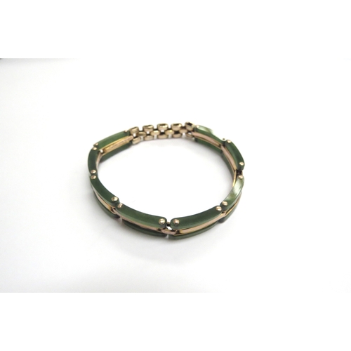 9338 - A gold and jade panel bracelet, expanding sprung strap stamped 9ct, 13.9g total           (C)