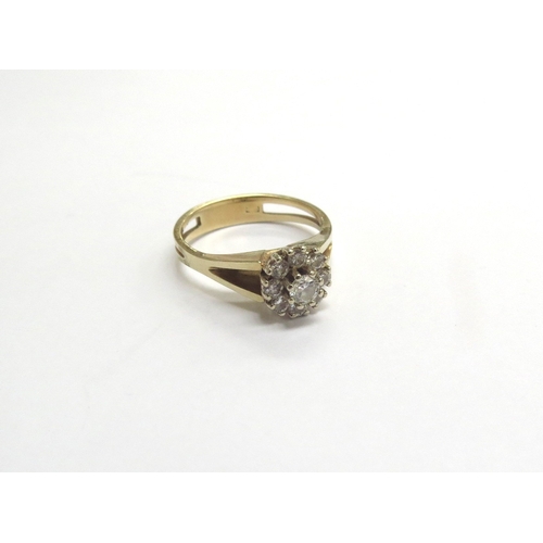 9189 - A diamond daisy ring with open shoulders, marks rubbed. Size N, 3.6g   (C)