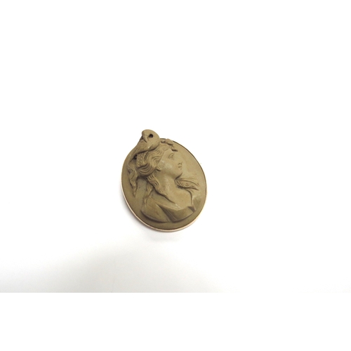 9397 - A 9ct gold carved lava cameo brooch, high profile of a female with a bird to head, 4cm x 3.2cm