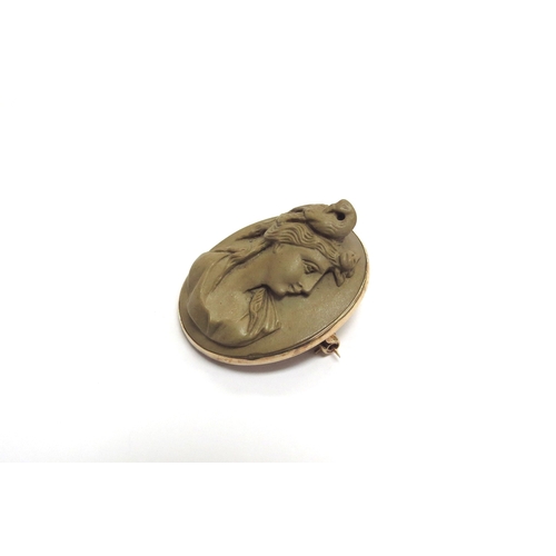 9397 - A 9ct gold carved lava cameo brooch, high profile of a female with a bird to head, 4cm x 3.2cm