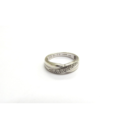 9396 - A 9ct white gold diamond line crossover band. Size K, 2.5g     (C)