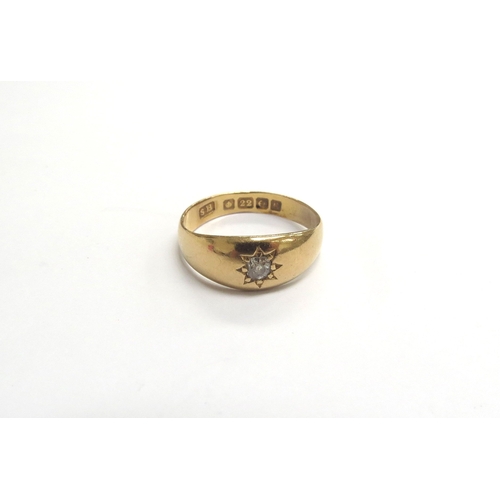 9339 - A 22ct gold single diamond set gypsy ring. Size R, 5g         (C)