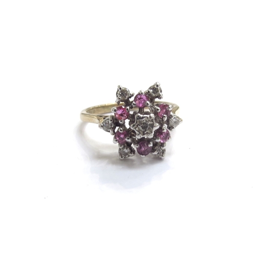 9454 - A 9ct gold ruby and diamond cluster ring. Size N/O, 3.1g