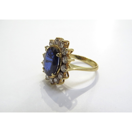 9055 - A sapphire and diamond cluster ring the central oval sapphire 11.5mm x 8.5mm, 3.47ct approx set in f... 