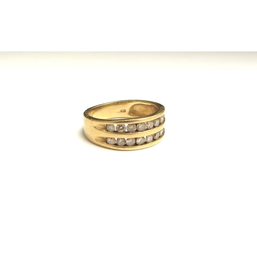 9129 - A gold ring set with two channels of diamonds, stamped 18k. Size O, 5g