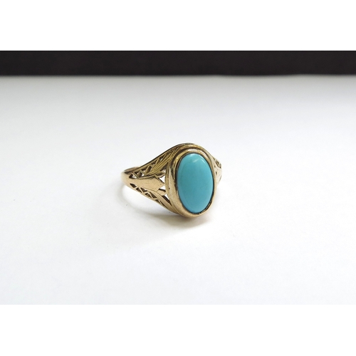 9261 - An unmarked gold ring with an oval turquoise, pierced shoulders. Size O/P, 2.7g