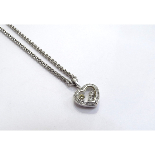 9307 - A white gold Chopard “Happy Diamonds” pendant set with 3 “floating” diamonds within a diamond framed... 