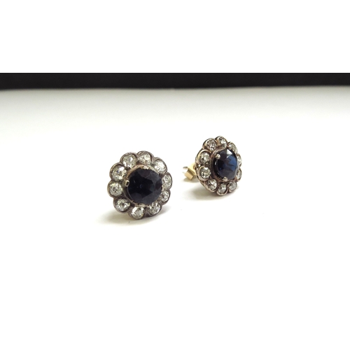 9419 - A pair of sapphire and diamond cluster earrings, the central circular sapphire 6mm framed by 10 old ... 