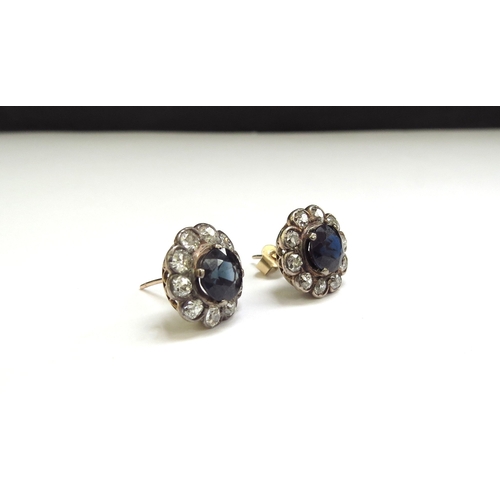 9419 - A pair of sapphire and diamond cluster earrings, the central circular sapphire 6mm framed by 10 old ... 