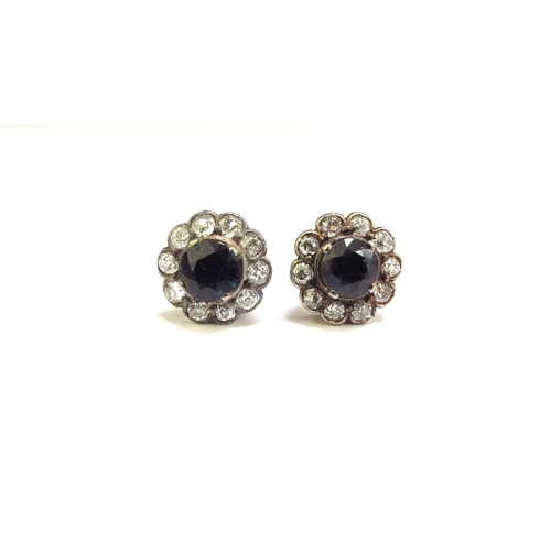 9419 - A pair of sapphire and diamond cluster earrings, the central circular sapphire 6mm framed by 10 old ... 