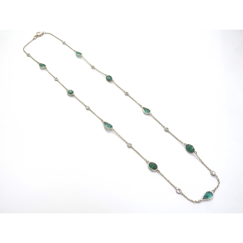 9425 - An emerald and diamond necklace with equally spaced stones on trace link chain, four oval emeralds a... 