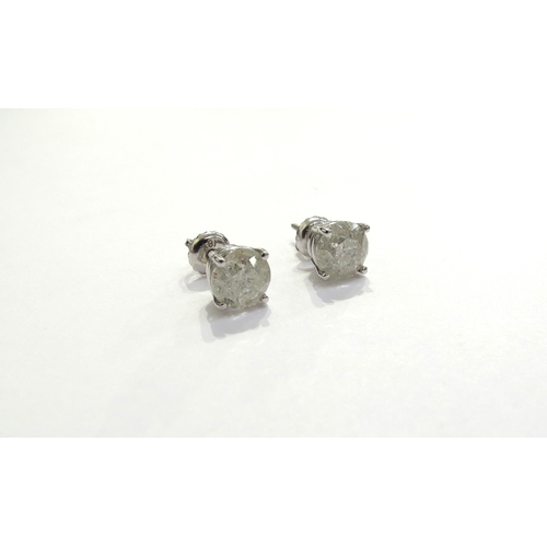 9351 - A pair of diamond stud earrings 1.15ct each approx in four claw white gold setting, stamped 14k, 1.6... 