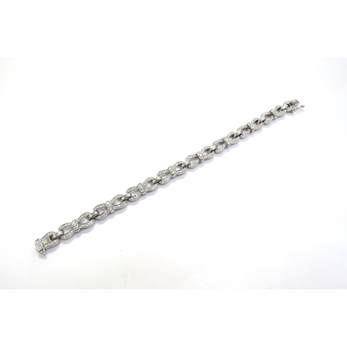 9442 - A Tiffany and Co white gold and diamond bracelet, brilliant cut diamonds set in bow style links, 4.2... 