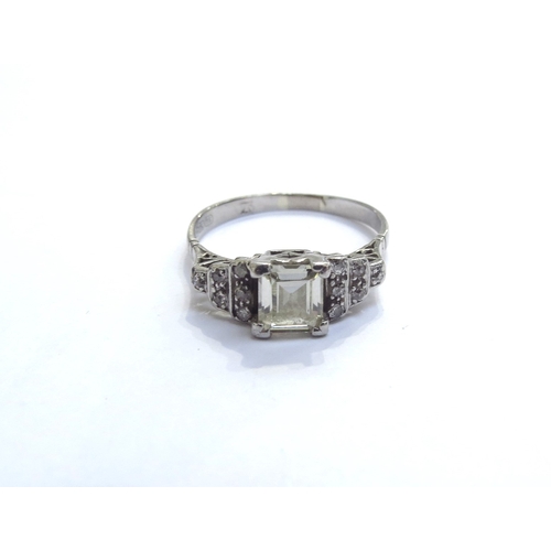 9010 - An 18ct white gold diamond ring, the centre square stone flanked by stepped diamond shoulders. Size ... 