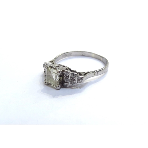 9010 - An 18ct white gold diamond ring, the centre square stone flanked by stepped diamond shoulders. Size ... 