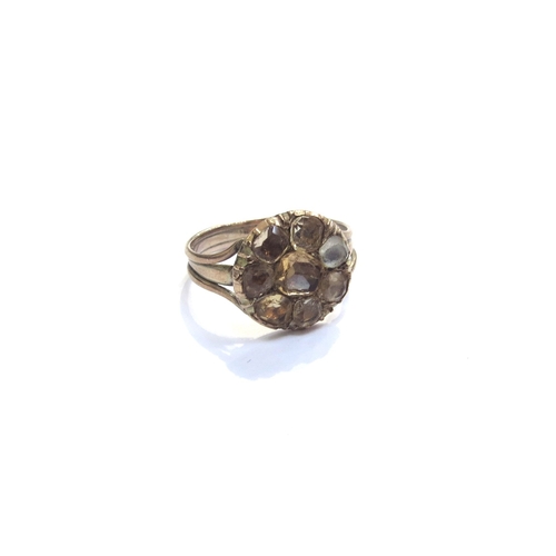 9231 - An unmarked gold ring with citrine set flower. Size M, 2.6g