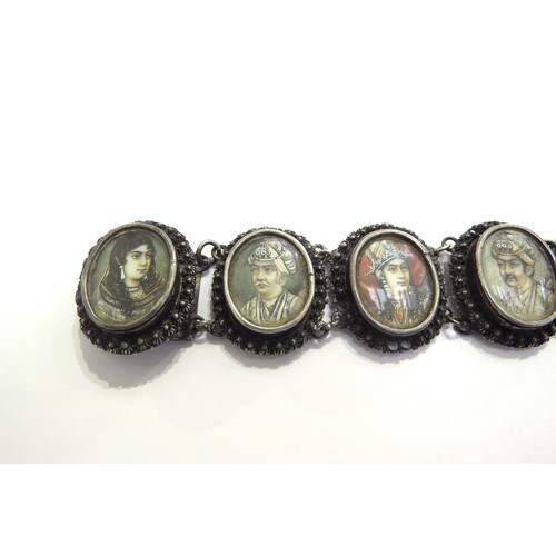 9444 - A white metal Indian ivory portrait bracelet depicting seven Mughals in oval panels, the names engra... 