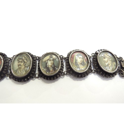 9444 - A white metal Indian ivory portrait bracelet depicting seven Mughals in oval panels, the names engra... 