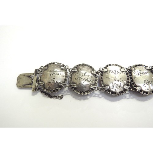 9444 - A white metal Indian ivory portrait bracelet depicting seven Mughals in oval panels, the names engra... 