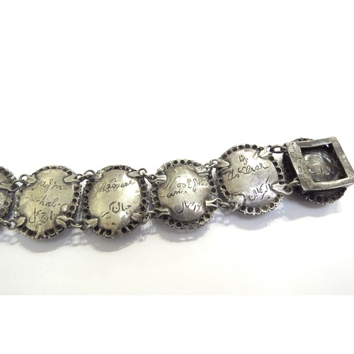 9444 - A white metal Indian ivory portrait bracelet depicting seven Mughals in oval panels, the names engra... 