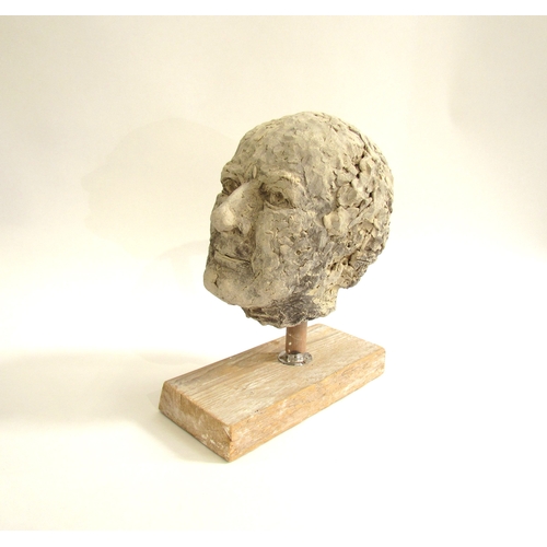 7553 - A ceramic hand worked studio sculpture of a mans head, set on a wooden plinth base. 31cm high