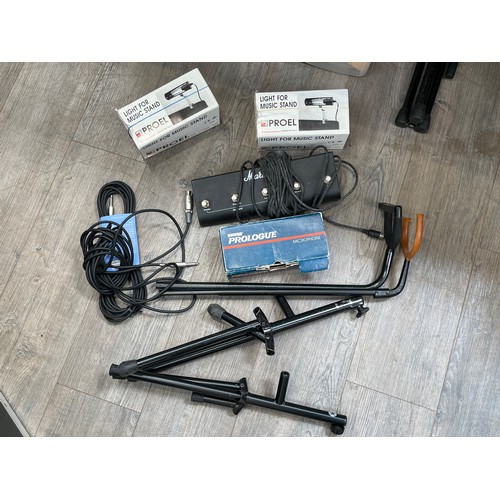 5162 - A quantity of equipment including two microphone stand, two guitar stands, music stand lights, Shure... 