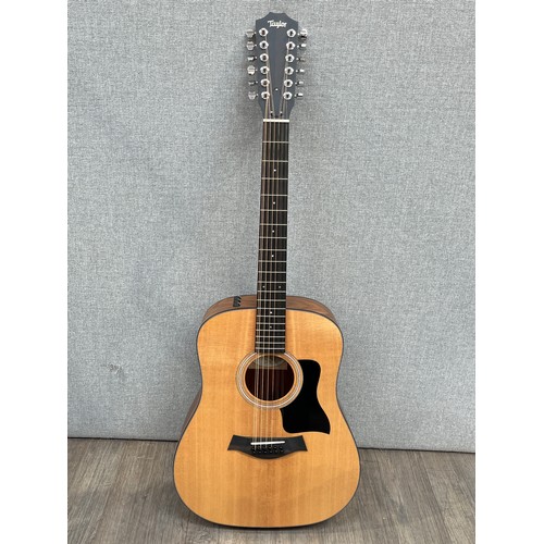 5147 - A Taylor 150E 100 Series electro acoustic 12 string guitar, sitka spruce top, walnut sides and back,... 