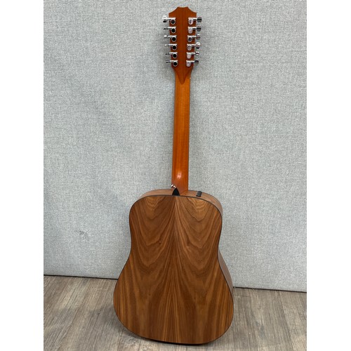 5147 - A Taylor 150E 100 Series electro acoustic 12 string guitar, sitka spruce top, walnut sides and back,... 