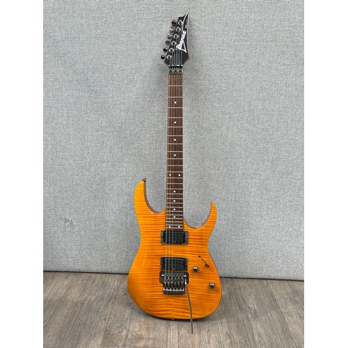 5138 - An Ibanez RG320FM electric guitar with figured amber body, serial no. CP04106785, with soft case