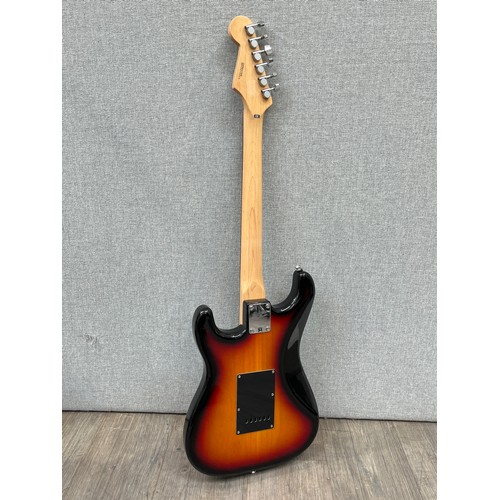 5134 - A Fender Squier Stratocaster electric guitar, sunburst body with white guard and Indian rosewood fin... 